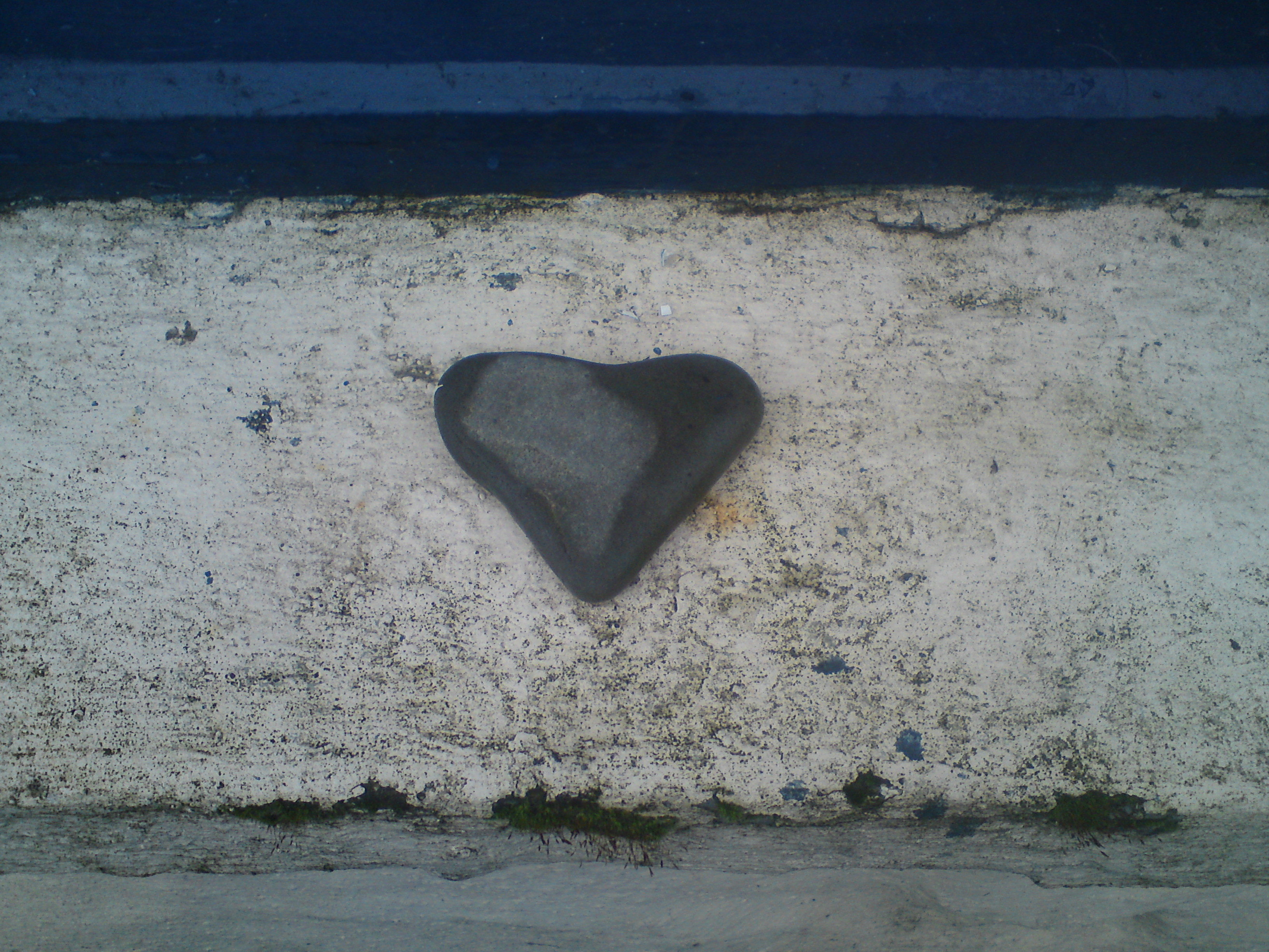 A heart shaped stone on a window cill to represent feelings